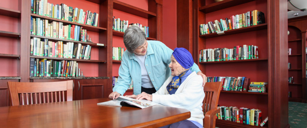 Residents read together in the library
